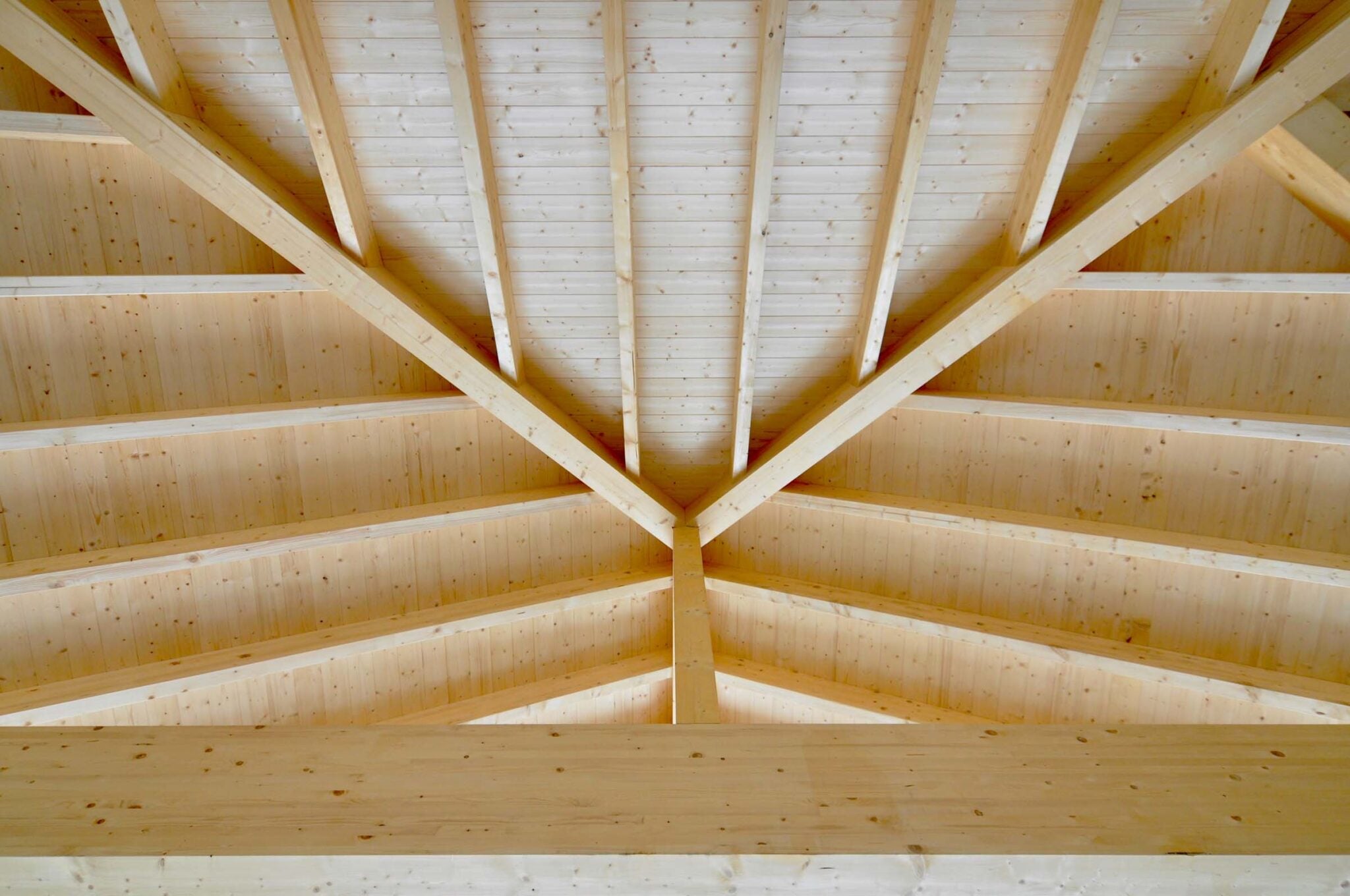 Firstdetail eines neuen Holzdachstuhls mit symmetrischen Sparren
