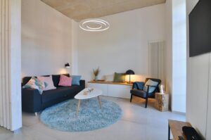 Bright living room after renovation with sofa and round carpet